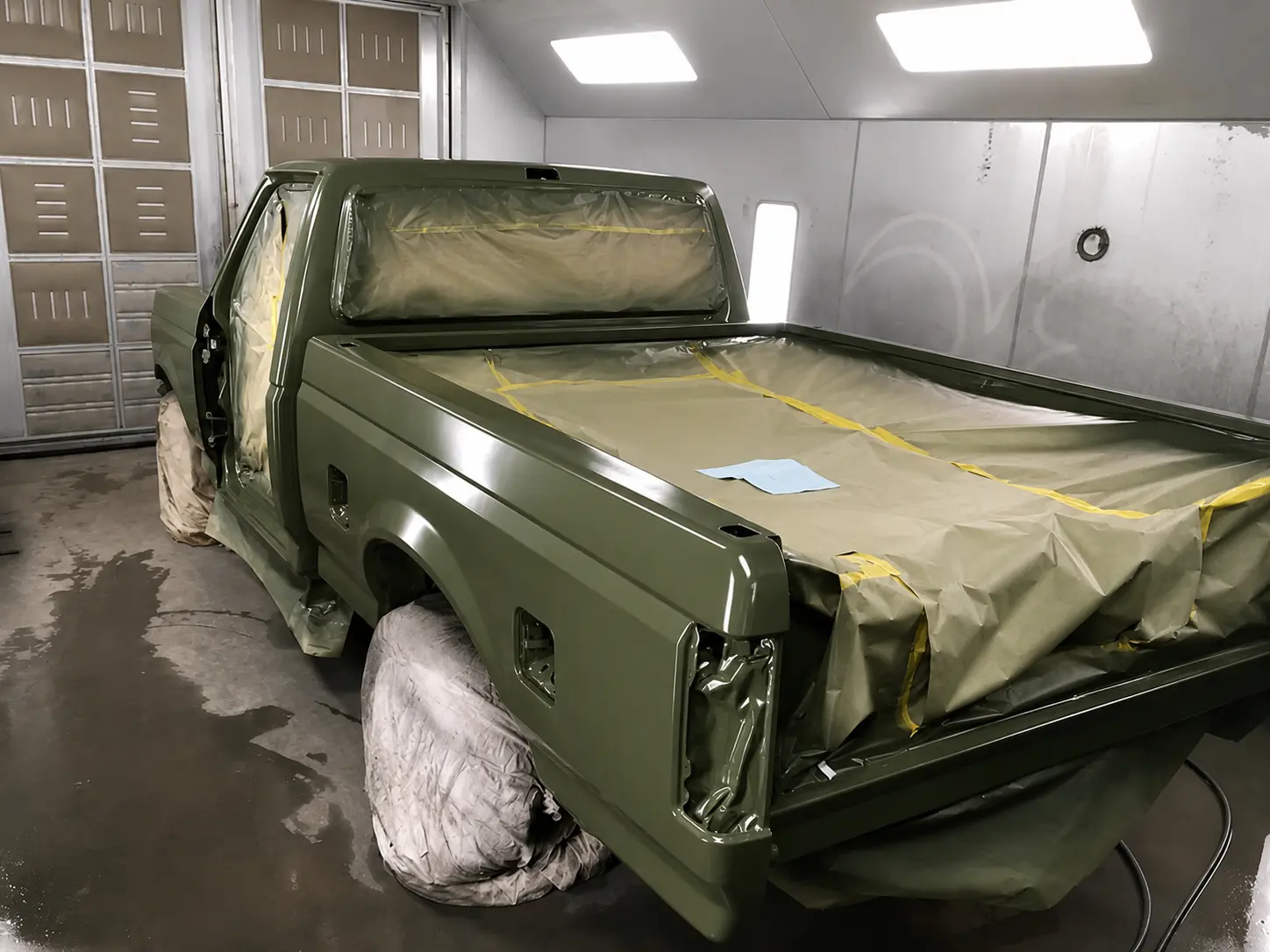 Army green truck with a freshly painted finish after auto body repair in Eugene, OR
