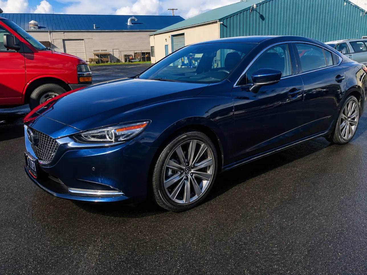 Blue four-wheel vehicle receiving mechanical repair service in Eugene, OR